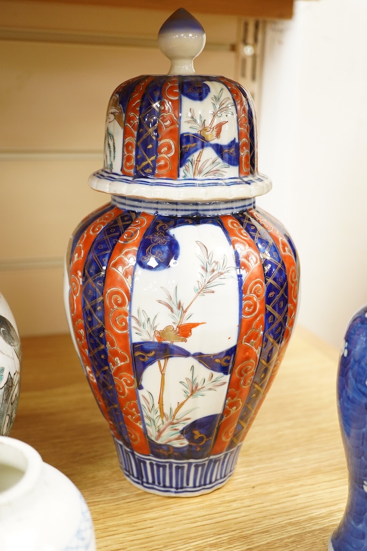 An Imari vase and cover-28cm high, a Chinese jar and prunus vase and a small blue and white jar.